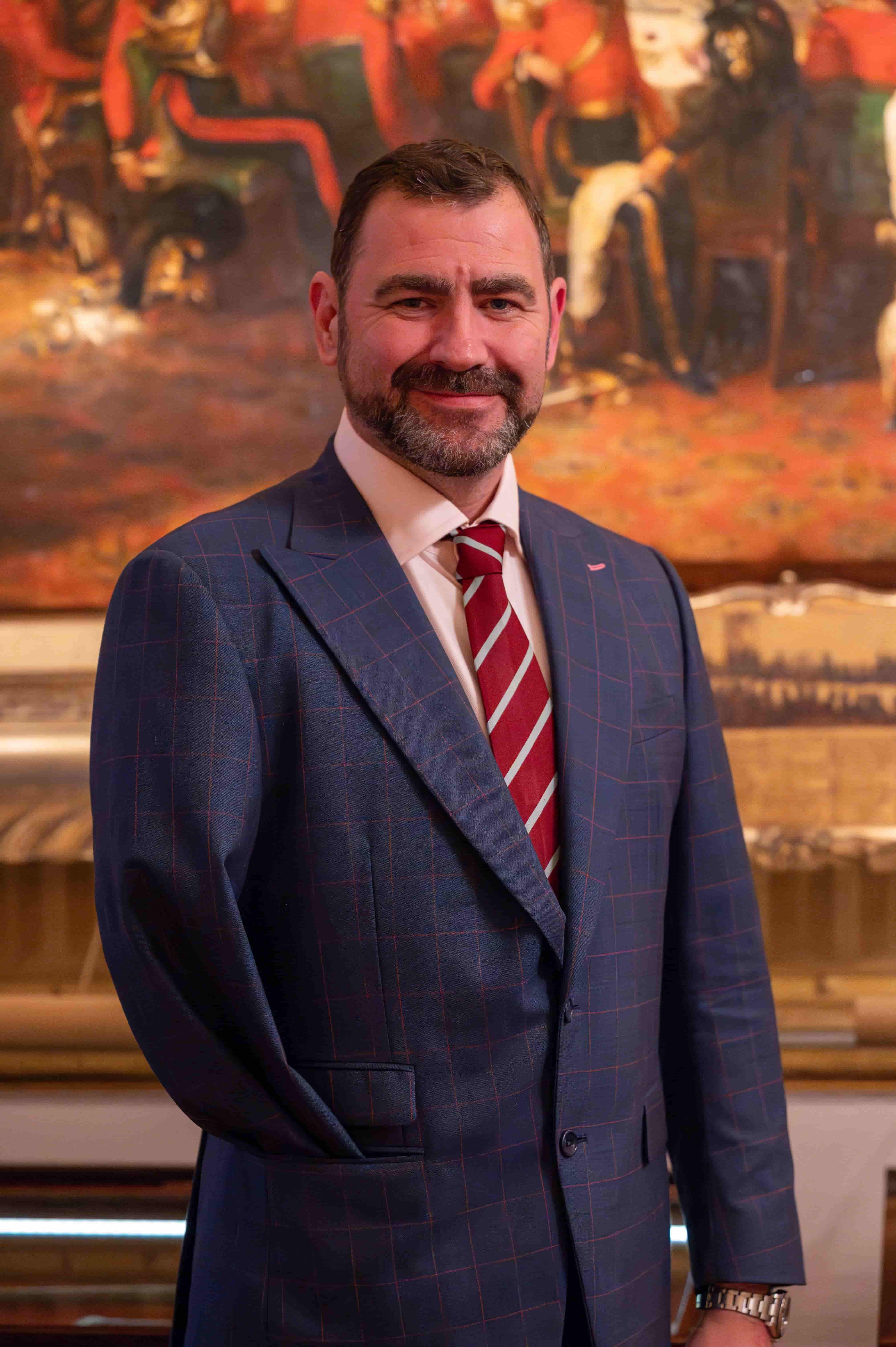 Portrait of Andy Reid MBE, veteran at Apsley House, Duke of Wellington's residence with painting in background